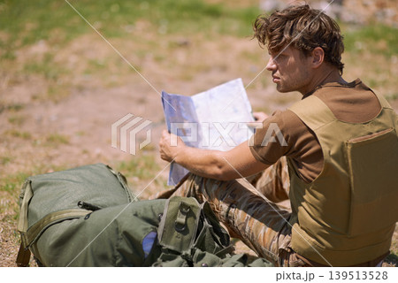 Soldier with map on battlefield, planning battle location or tactical operation goals for mission in war. Man is outdoor at military base camp, check strategy paperwork with army target and attack Soldier with map on battlefield, planning battle location or tactical operation goals for mission in war. Man is outdoor at military base camp, check strategy paperwork with army target and attack 139513528