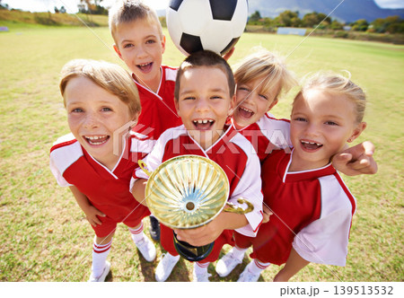 Celebration, soccer team and children with cup, boys and girls with victory, support or proud. Achievement, sports and friendship, together and happy for win, ready for game or physical activity 139513532
