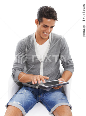 Man, tablet and smile on chair in studio for social media post, reading ebook and blog on white background. Happy model scroll on digital technology for connection, download app and online shopping Man, tablet and smile on chair in studio for social media post, reading ebook and blog on white background. Happy model scroll on digital technology for connection, download app and online shopping 139513580