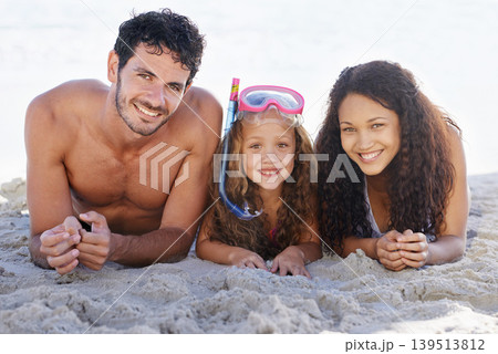 Happy family, portrait and relax on beach for bonding, vacation or outdoor holiday weekend together. Face of dad, mom and kid smile lying on sand by the ocean coast for fun summer break in nature Happy family, portrait and relax on beach for bonding, vacation or outdoor holiday weekend together. Face of dad, mom and kid smile lying on sand by the ocean coast for fun summer break in nature 139513812