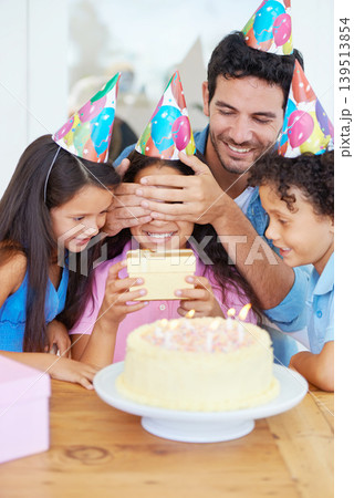 Birthday cake, kid and gift with covered eyes, surprise and happy family for celebration, siblings and dad. Singing, smile and love with presents, together and parent for childhood, party or home Birthday cake, kid and gift with covered eyes, surprise and happy family for celebration, siblings and dad. Singing, smile and love with presents, together and parent for childhood, party or home 139513854