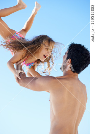 Happy father, beach and lifting girl in bonding, vacation or outdoor holiday weekend together. Dad, child or kid smile for love, support or fun summer break by ocean coast with blue sky background 139513882