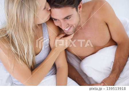 Above, bedroom or happy couple kiss on vacation or romantic honeymoon holiday to celebrate marriage. Morning, love or people hug to cuddle in home, house or hotel together with romance, bond or care Above, bedroom or happy couple kiss on vacation or romantic honeymoon holiday to celebrate marriage. Morning, love or people hug to cuddle in home, house or hotel together with romance, bond or care 139513918