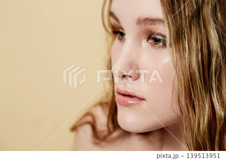 Woman, face and beauty, natural makeup and skincare with wellness, dermatology and glow on beige background. Healthy skin, cosmetics and mockup space, young model thinking about treatment in studio 139513951
