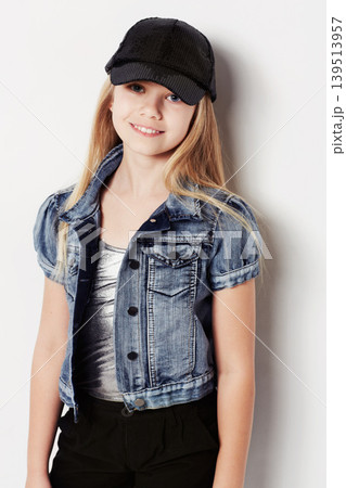 Child, portrait and fashion in studio, cool and confidence by white background. Female person, girl and casual clothing or style by backdrop, kid and denim jacket pride or smiling for trendy cap Child, portrait and fashion in studio, cool and confidence by white background. Female person, girl and casual clothing or style by backdrop, kid and denim jacket pride or smiling for trendy cap 139513957