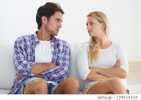 Couple, angry and living room couch with disagreement, upset and staring with anger, fight or mad. Divorce, betrayal and relationship with cheating, stress and argument for marriage, home or toxic Couple, angry and living room couch with disagreement, upset and staring with anger, fight or mad. Divorce, betrayal and relationship with cheating, stress and argument for marriage, home or toxic 139514318