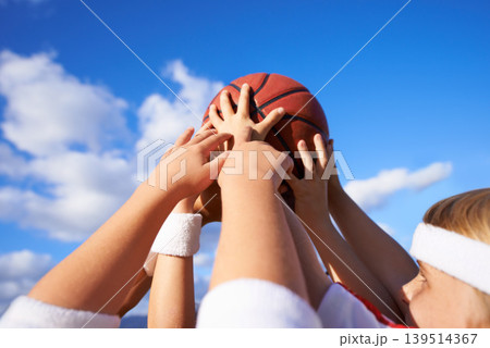 People, hands and basketball in teamwork for sports motivation, unity or community with blue sky background. Group of players holding ball up in air for friendly match or outdoor game in nature People, hands and basketball in teamwork for sports motivation, unity or community with blue sky background. Group of players holding ball up in air for friendly match or outdoor game in nature 139514367