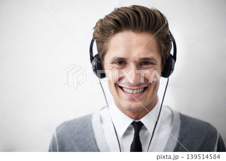 Business man, portrait and headphones for music, smile and listening to radio by wall background. Employee, person and happy with sound, hearing and audio streaming subscription for podcast with tech Business man, portrait and headphones for music, smile and listening to radio by wall background. Employee, person and happy with sound, hearing and audio streaming subscription for podcast with tech 139514584