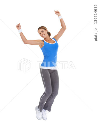 Woman, jump and fitness celebration in studio for exercise success, workout achievement or body goals and dance. Sports model with fist, energy and portrait for training results on a white background Woman, jump and fitness celebration in studio for exercise success, workout achievement or body goals and dance. Sports model with fist, energy and portrait for training results on a white background 139514656