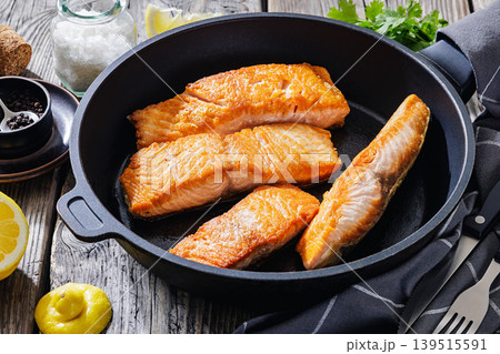 Pan-seared salmon fillets on a skillet, close-up Pan-seared salmon fillets on a skillet, close-up 139515591