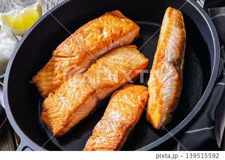 Pan-seared salmon fillets on a skillet, close-up 139515592