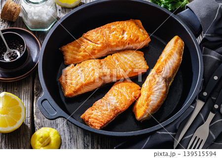 Pan-seared salmon fillets on a skillet, close-up 139515594