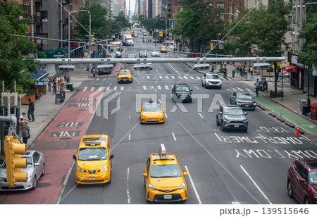 New york, usa august 17,2024. Yellow taxis and cars weave through a busy manhattan street lined with buildings and pedestrians during daytime city rush hour New york, usa august 17,2024. Yellow taxis and cars weave through a busy manhattan street lined with buildings and pedestrians during daytime city rush hour 139515646