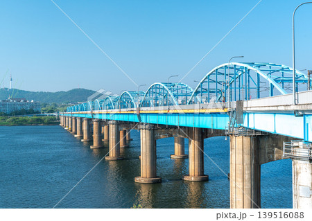 Seoul, South Korea - Mar. 01, 2026 : Scenic View of Dongjak Bridge over Han River with Namsan Seoul Tower under Clear Blue Sky in Spring 139516088