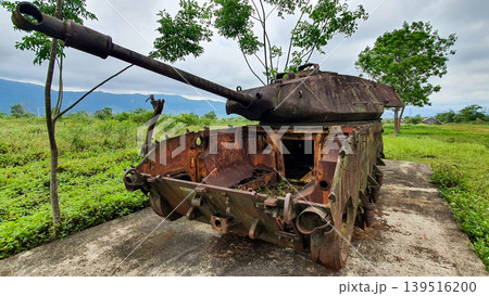 Damaged Rusty Tank On Display At Ta Con Airport Relics (Also Called Khe Sanh Combat Base) In Khe Sanh Area Of Quang Tri Province, Vietnam. Damaged Rusty Tank On Display At Ta Con Airport Relics (Also Called Khe Sanh Combat Base) In Khe Sanh Area Of Quang Tri Province, Vietnam. 139516200