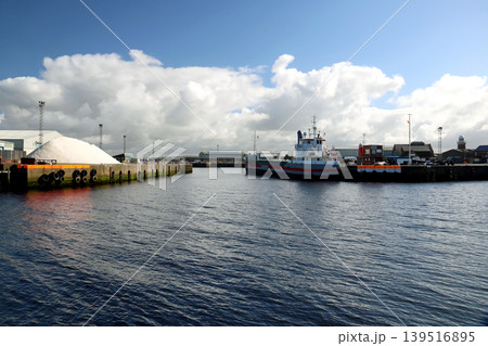 View of Ayr Harbour in South West Scotland with Moored Cargo Ship and Port Buildings View of Ayr Harbour in South West Scotland with Moored Cargo Ship and Port Buildings 139516895