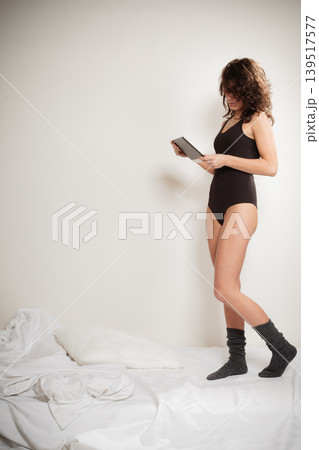 Sexy lazy girl with tablet touchpad in bedroom Sexy lazy girl with tablet touchpad in bedroom 139517577