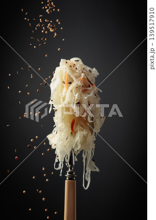 Traditional German sauerkraut with spices on a fork. Traditional German sauerkraut with spices on a fork. 139517910