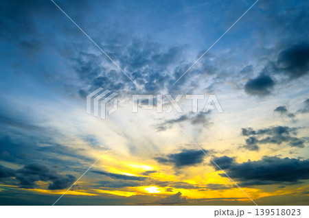 Dramatic Sunset Sky with Vibrant Blue and Yellow Clouds Dramatic Sunset Sky with Vibrant Blue and Yellow Clouds 139518023