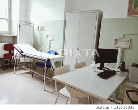 Interior of an old-fashioned medical examination room with a vintage treatment table. Interior of an old-fashioned medical examination room with a vintage treatment table. 139519038