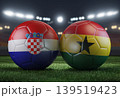 Two soccer balls in flags colors on a stadium blurred background. Croatia vs Ghana. 3D image. 139519423