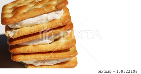 Stack of sandwich crackers filled with creamy filling Stack of sandwich crackers filled with creamy filling 139522108