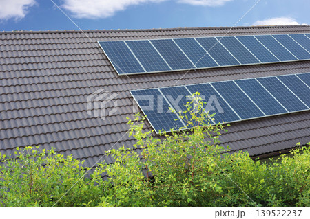 Solar panels installed on a dark tiled roof of a house Solar panels installed on a dark tiled roof of a house 139522237
