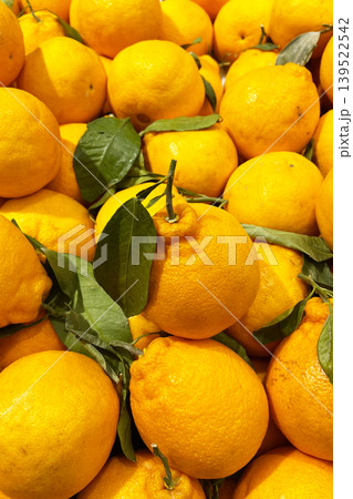 Fresh oranges with green leaves at fruit market Fresh oranges with green leaves at fruit market 139522542