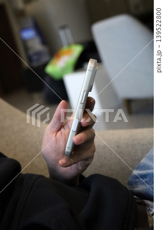 Person holding white smartphone indoors 139522800