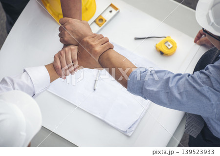 Group of multiracial people Teamwork meeting join hands Engineer Manager Foreman fist bump together. Close up diversity engineer people hands partner teams. Business connection team join partnership Group of multiracial people Teamwork meeting join hands Engineer Manager Foreman fist bump together. Close up diversity engineer people hands partner teams. Business connection team join partnership 139523933