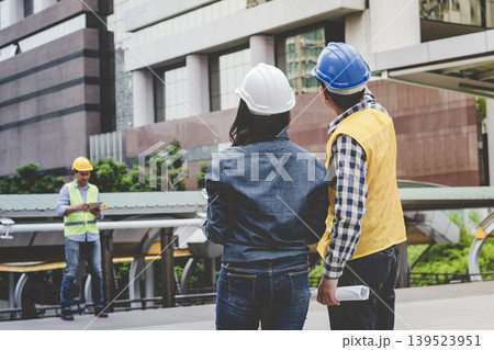 Banner Two engineer women businessman look at blueprint architecture building contractor. Team Engineer holding project planing partner teamwork. Two woman man meeting teamwork with copy space Banner Two engineer women businessman look at blueprint architecture building contractor. Team Engineer holding project planing partner teamwork. Two woman man meeting teamwork with copy space 139523951