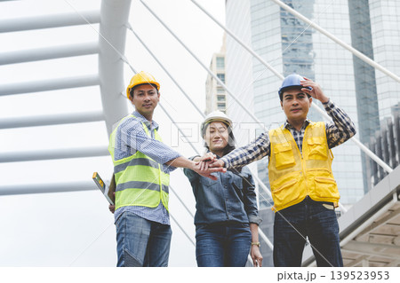 Group of multiracial people Teamwork meeting join hands Engineer Manager Foreman fist bump together. Close up diversity engineer people hands partner teams. Business connection team join partnership 139523953