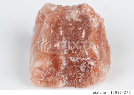 Salt mineral surface. Wellness mineral rock coated with granular coarse salt layers. Pink halite mineral stone displaying rough texture and crystalline salt surface layers Salt mineral surface. Wellness mineral rock coated with granular coarse salt layers. Pink halite mineral stone displaying rough texture and crystalline salt surface layers 139524270