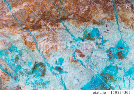 Elaborate network of fractures in turquoise mimicking cartographic images. Complex fractured turquoise surface featuring mineral deposits that resemble abstract map patterns 139524365