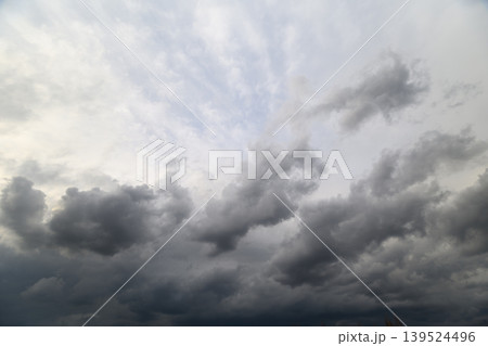 Overcast skies signal approaching storm. Brewing storm darkens vast sky above us. Thick gray clouds gather swiftly indicating impending and threatening thunderstorm Overcast skies signal approaching storm. Brewing storm darkens vast sky above us. Thick gray clouds gather swiftly indicating impending and threatening thunderstorm 139524496