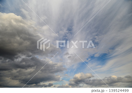 Sky abounds with turbulent storm formations. Vast sky showcases intense swirling storm clouds. Enormous sky filled with striking and chaotic storm cloud patterns 139524499