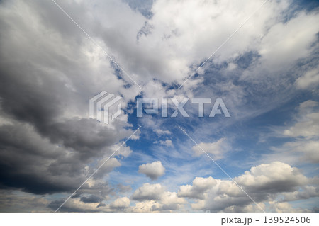 Storm clouds forecast. Ominous weather scene with contrasting stormy and clear areas. Dramatic weather imagery showing dark storm clouds encircling bright sky opening Storm clouds forecast. Ominous weather scene with contrasting stormy and clear areas. Dramatic weather imagery showing dark storm clouds encircling bright sky opening 139524506