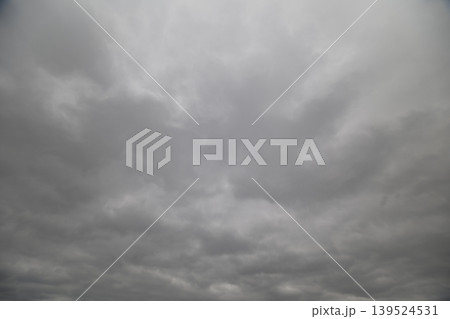 Dramatic cloudy sky before storm, heavy cloud banks and deep gray gradients, turbulent textures suggesting incoming weather, high tension for forecast and editorial use 139524531