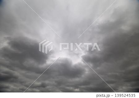 Gray overcast sky. Dark clouds create moody atmosphere. Heavy gray clouds form textured overcast scene. Thick gray clouds produce diffuse light and atmospheric depth Gray overcast sky. Dark clouds create moody atmosphere. Heavy gray clouds form textured overcast scene. Thick gray clouds produce diffuse light and atmospheric depth 139524535