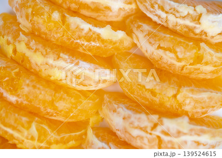 Fresh orange pieces arranged attractively under sunlight. Radiant presentation featuring neatly stacked citrus segments against pristine backdrop illuminated by sunlight Fresh orange pieces arranged attractively under sunlight. Radiant presentation featuring neatly stacked citrus segments against pristine backdrop illuminated by sunlight 139524615