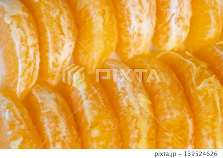Sunlit citrus pieces inspire refreshing summer feelings. Vivid mandarin segments shimmering with juice and warmth capture essence of summer refreshment and citrus energy Sunlit citrus pieces inspire refreshing summer feelings. Vivid mandarin segments shimmering with juice and warmth capture essence of summer refreshment and citrus energy 139524626