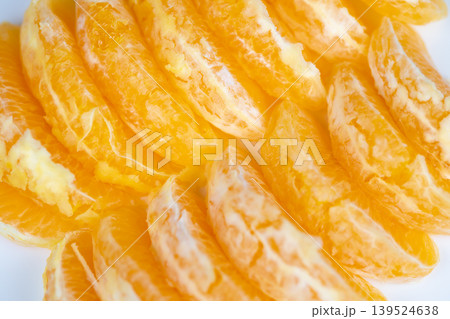 Fresh juicy orange slices arranged for vibrant breakfast scene, glistening pulp, soft white background, natural light accentuating bright color and tempting texture Fresh juicy orange slices arranged for vibrant breakfast scene, glistening pulp, soft white background, natural light accentuating bright color and tempting texture 139524638