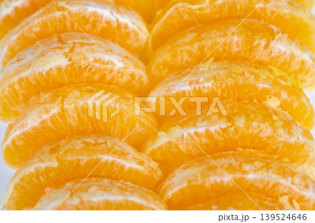 Colorful orange slices spread out. Closeup of lively orange slices on vibrant background. Playful arrangement of orange pieces with soft texture on colorful backdrop Colorful orange slices spread out. Closeup of lively orange slices on vibrant background. Playful arrangement of orange pieces with soft texture on colorful backdrop 139524646
