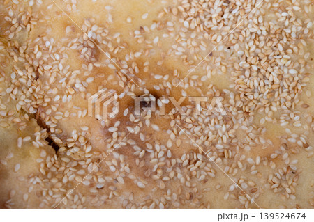 Detailed pastry surface. Precise sesame seed placement on baked bread mockup surface. Realistic sesame covered pastry surface ideal for packaging and branding presentations Detailed pastry surface. Precise sesame seed placement on baked bread mockup surface. Realistic sesame covered pastry surface ideal for packaging and branding presentations 139524674