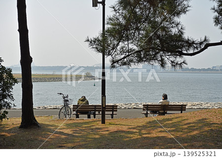 海を望む公園のベンチと人々 潮風を感じながら心解き放つ至福の休日 海を望む公園のベンチと人々 潮風を感じながら心解き放つ至福の休日 139525321
