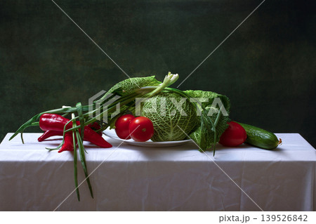 Still life with Savoy cabbage on a white tablecloth. 139526842