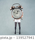 Woman holding alarm clock concept of time pressure 139527941