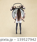 Woman hiding behind giant alarm clock deadline 139527942