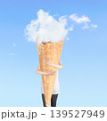 Person holding giant ice cream cone with cloud scoop 139527949