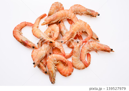 Fresh shrimp arranged on a white surface ready for cooking or serving in a meal 139527979